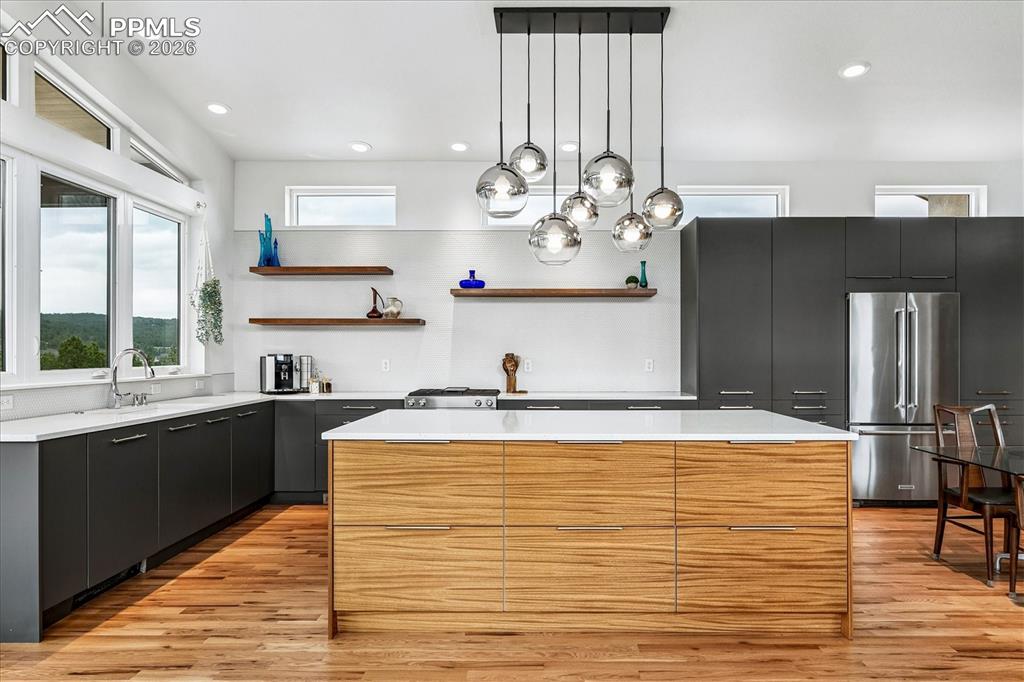 Image 18 of 50: Gourmet kitchen with solid oak flooring, mountain views, designer & recesse