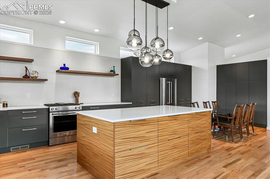 Image 21 of 50: Gourmet kitchen with solid oak flooring, designer & recessed lighting, cust