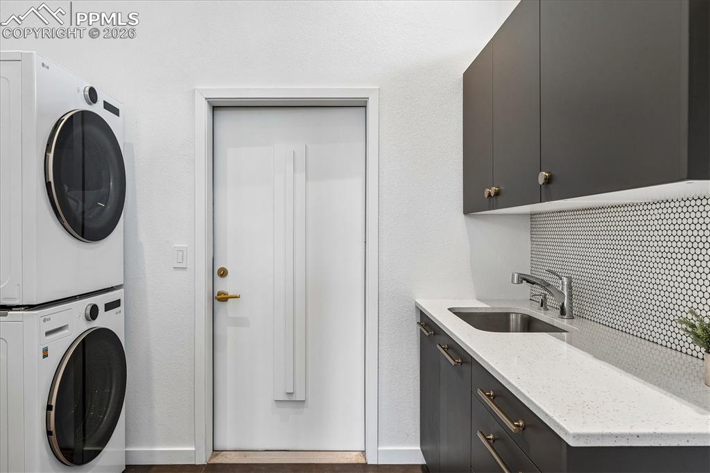 Image 26 of 50: Entry into the laundry room by barn door, including tile flooring, utility
