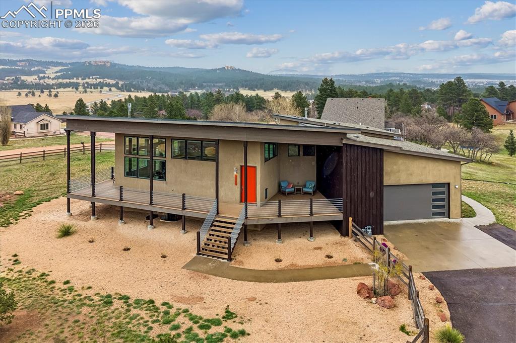 Image 3 of 50: Cloven Hoof Estates home in Monument on .77 acres with a wrap-around porch