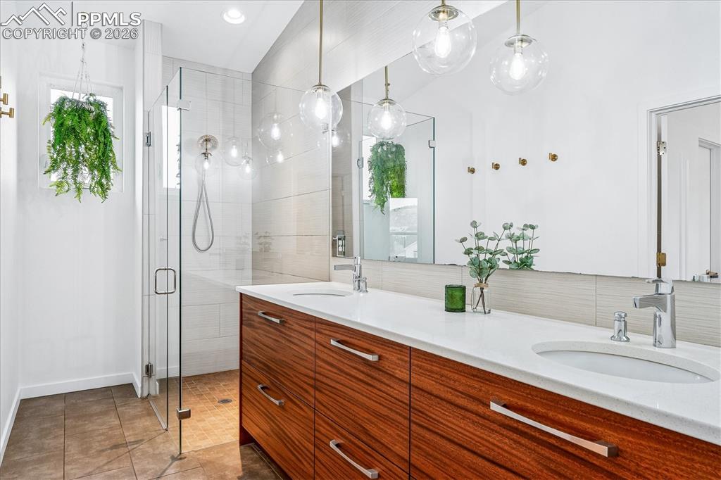 Image 31 of 50: Primary en suite bathroom with heated tile flooring, "Frost White" quartz c