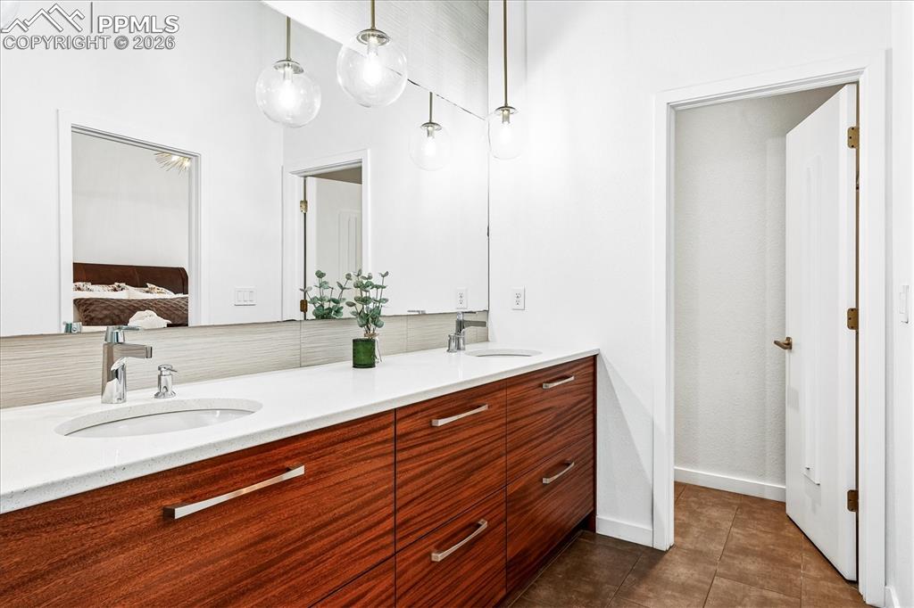 Image 32 of 50: Primary en suite bathroom with heated tile flooring, "Frost White" quartz c