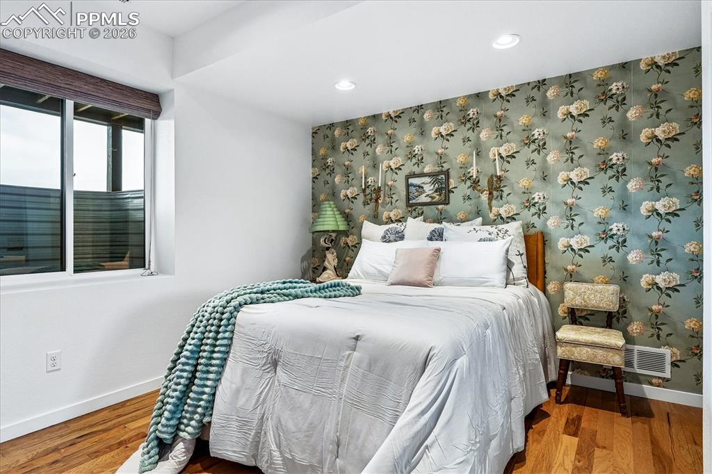 Image 34 of 50: Primary en suite basement bedroom with solid oak flooring, recessed lightin