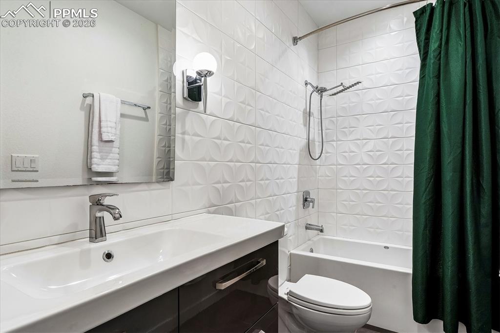 Image 35 of 50: Basement en suite bathroom with heated tile flooring, soaking tub, and desi