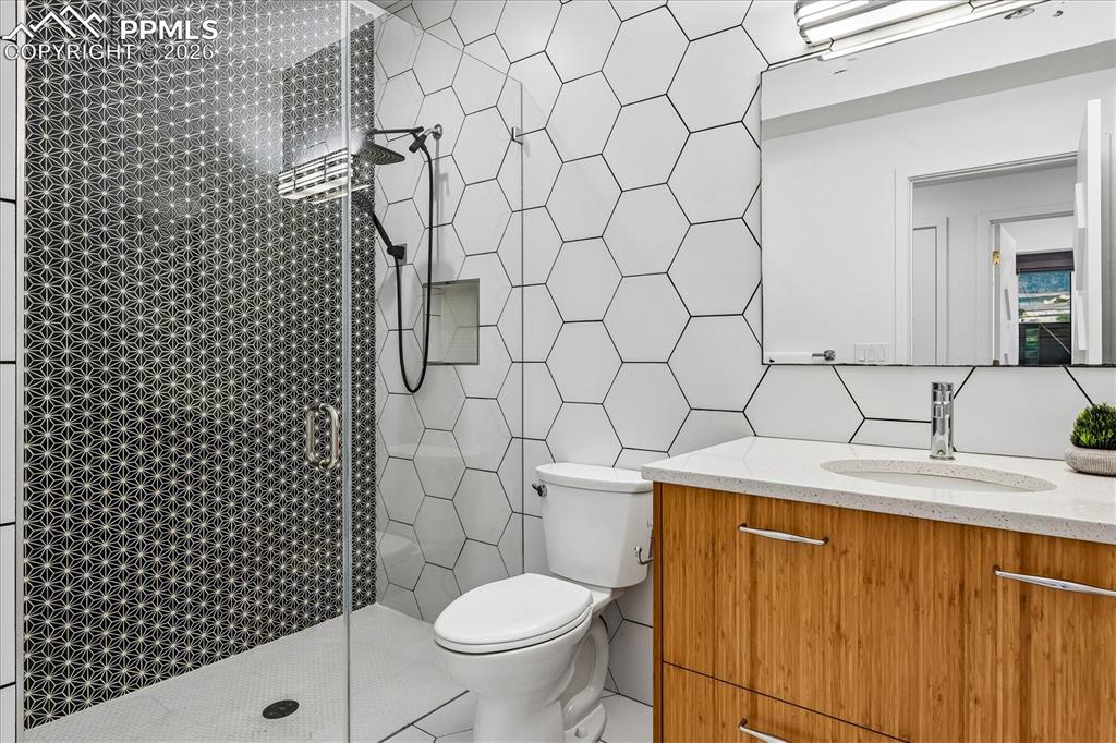 Image 37 of 50: Basement guest bathroom with heated tile flooring, designer & recessed ligh