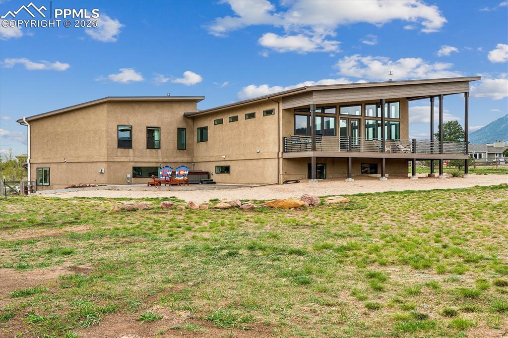 Image 4 of 50: Mid-Century Modern custom home surrounded by a wrap around porch, small pat