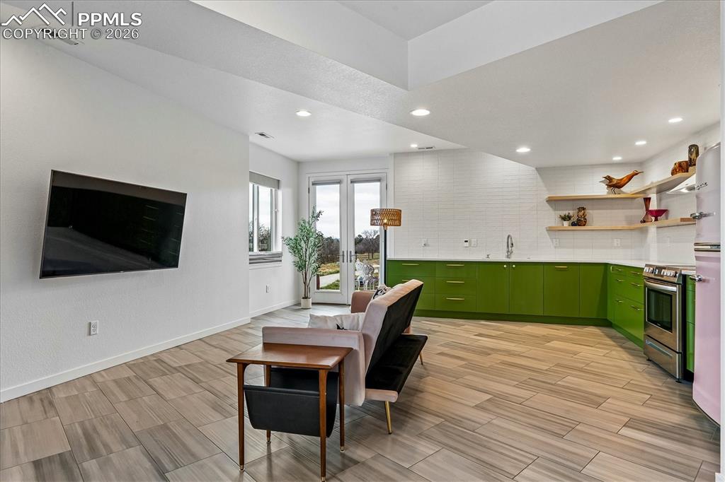 Image 40 of 50: Family room with and open layout including heated tile flooring, and a Jotu