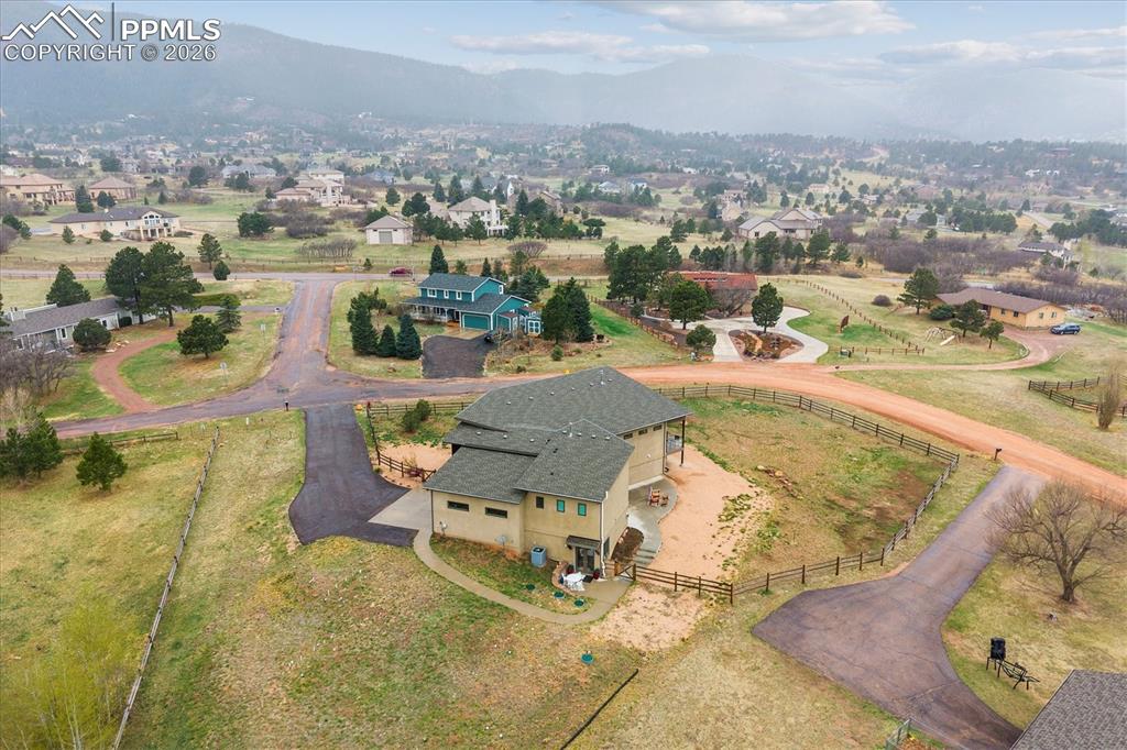 Image 45 of 50: Aerial view of the lot with paved driveway leading up to the home.