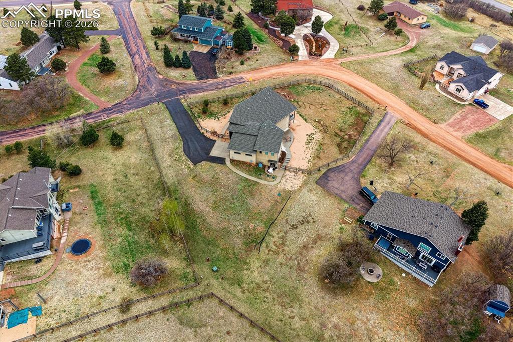 Image 47 of 50: Aerial view of the lot with paved driveway leading up to the home.