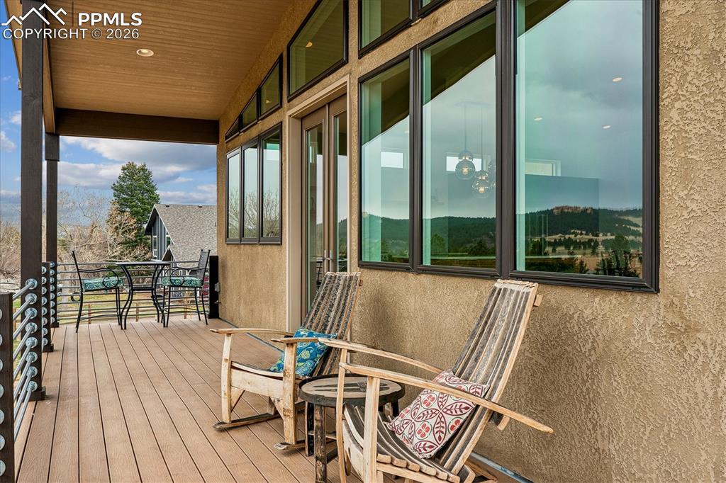 Image 8 of 50: The wrap-around porch has access through french doors into the kitchen/dini