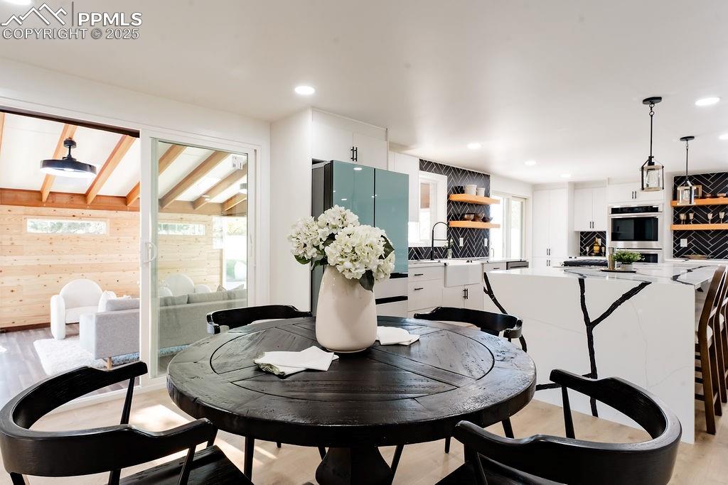 Image 12 of 43: Dining room featuring light wood-style flooring and recessed lighting