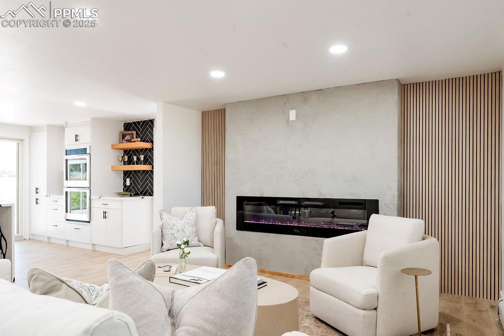 Image 19 of 43: Living room featuring recessed lighting and light wood finished floors