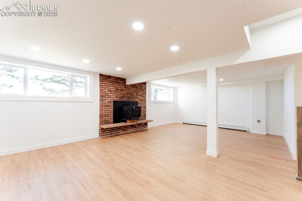 Image 33 of 43: Below grade area featuring light wood-style flooring, recessed lighting, a 