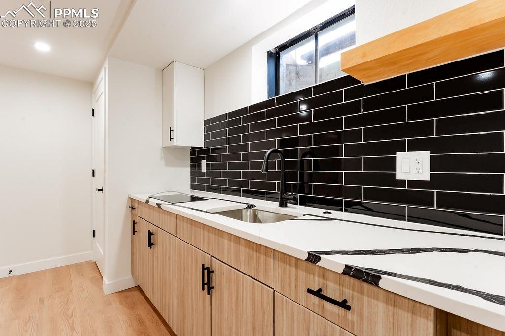 Image 35 of 43: 2nd Kitchen with light brown cabinets, tasteful backsplash, light wood-type