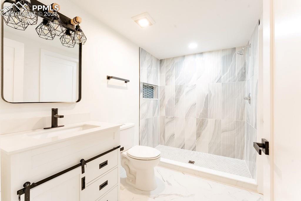 Image 36 of 43: 3/4 bath featuring vanity, a stall shower, and recessed lighting