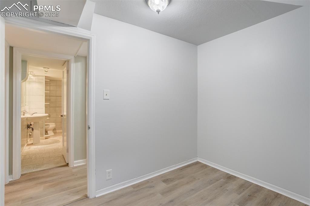Image 32 of 50: Empty room featuring light wood-style flooring and baseboards