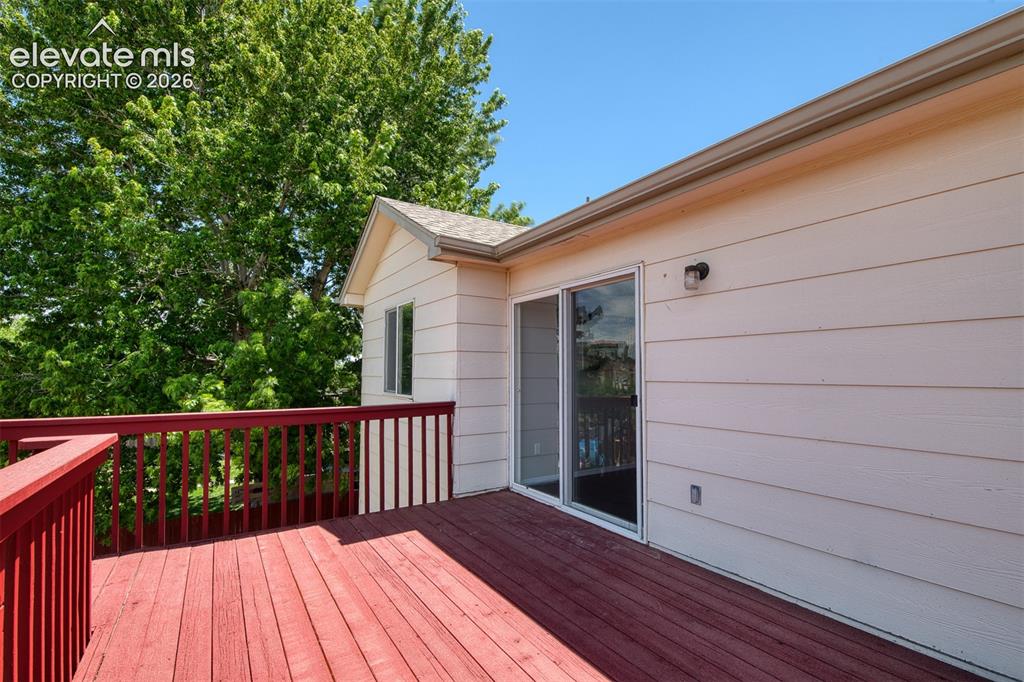 Image 17 of 46: Expansive wood-plank deck with a red finish and matching railing