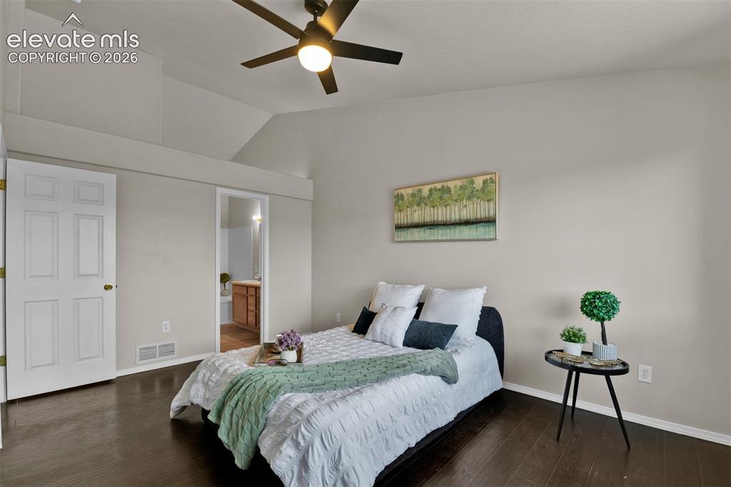 Image 19 of 46: Wood-finish flooring throughout, featuring a vaulted ceiling with a ceiling