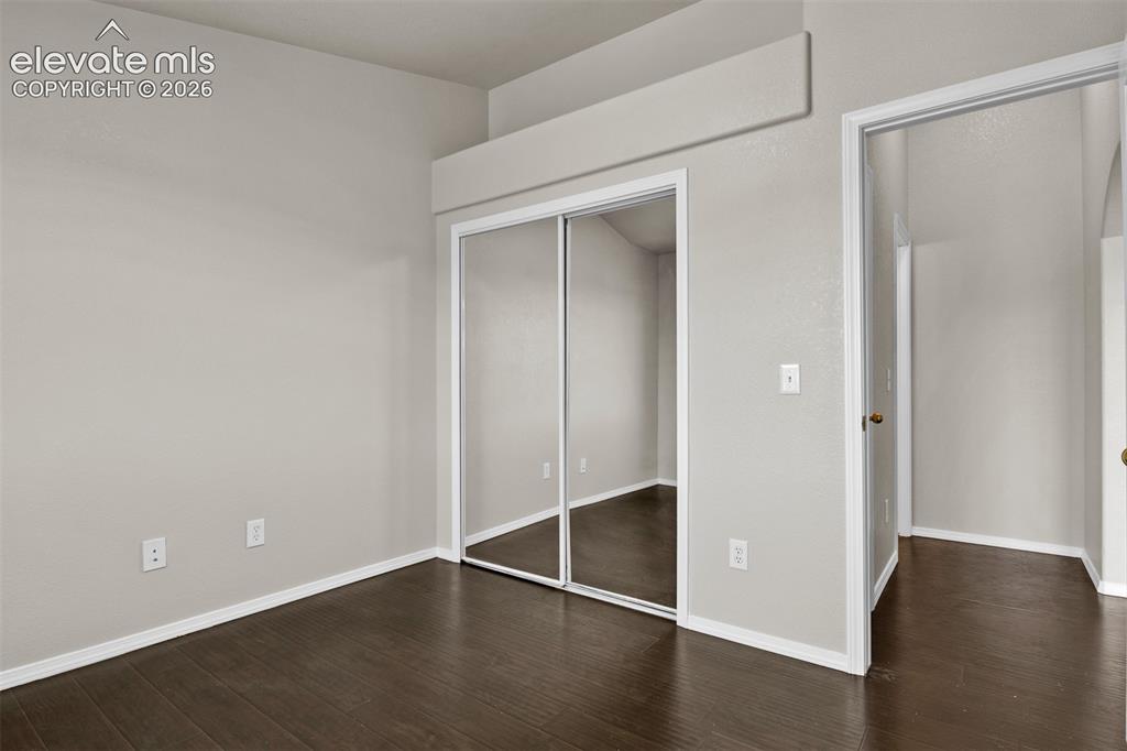 Image 23 of 46: Interior room featuring wood-finish flooring, light neutral wall paint, whi