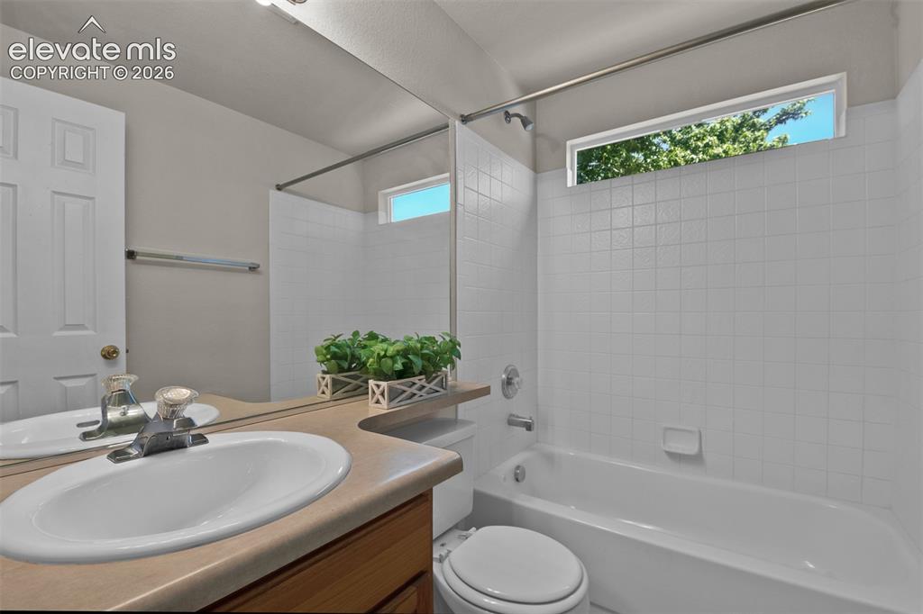 Image 24 of 46: Full bathroom featuring a single vanity, a combination tub and shower, a re