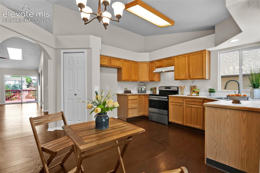 Image 5 of 46: Kitchen featuring wood-finish flooring, light wood cabinetry, and stainless
