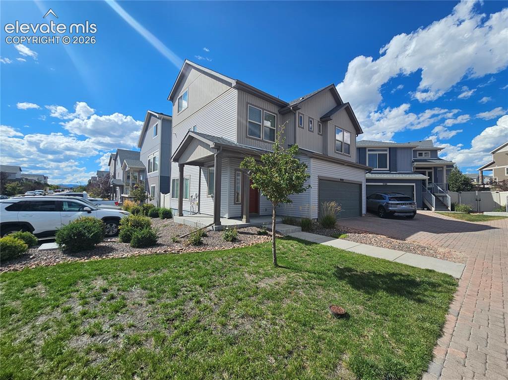 Image 1 of 23: Contemporary two-story exterior with a covered entry, attached garage, and