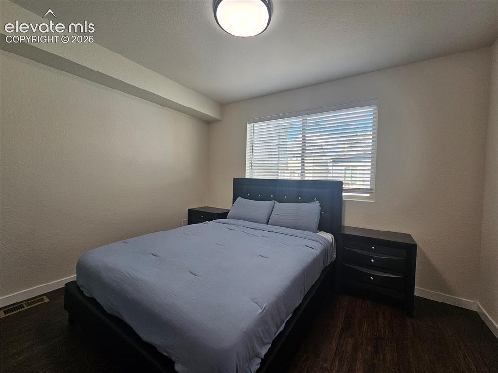 Image 10 of 23: Recessed window with horizontal blinds, dark wood-finish flooring, and a fl