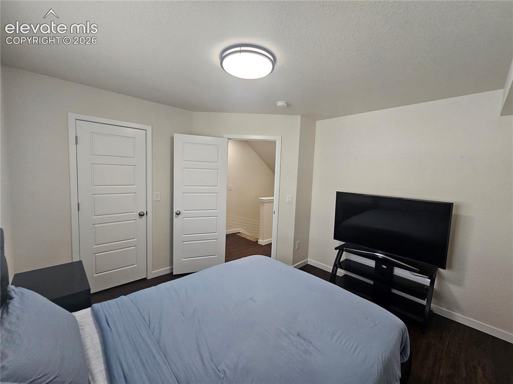Image 11 of 23: Room featuring wood-finish flooring, white paneled doors, and a ceiling-mou