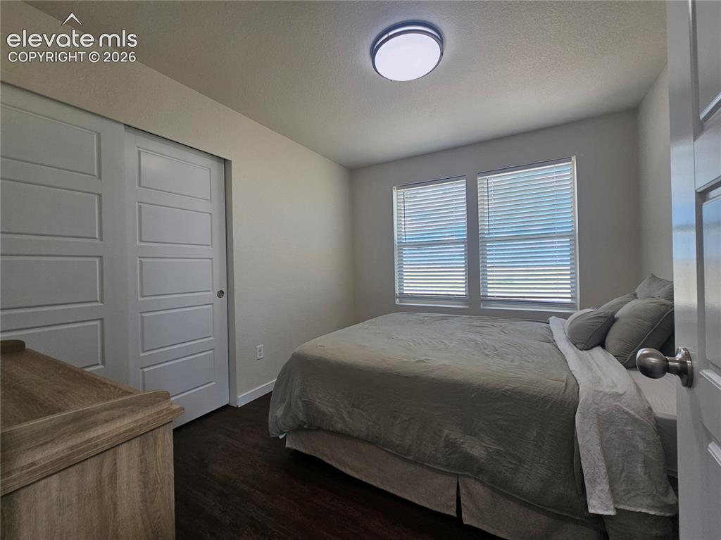 Image 17 of 23: Recessed windows with blinds, wood-finish flooring, and a flush-mount ceili
