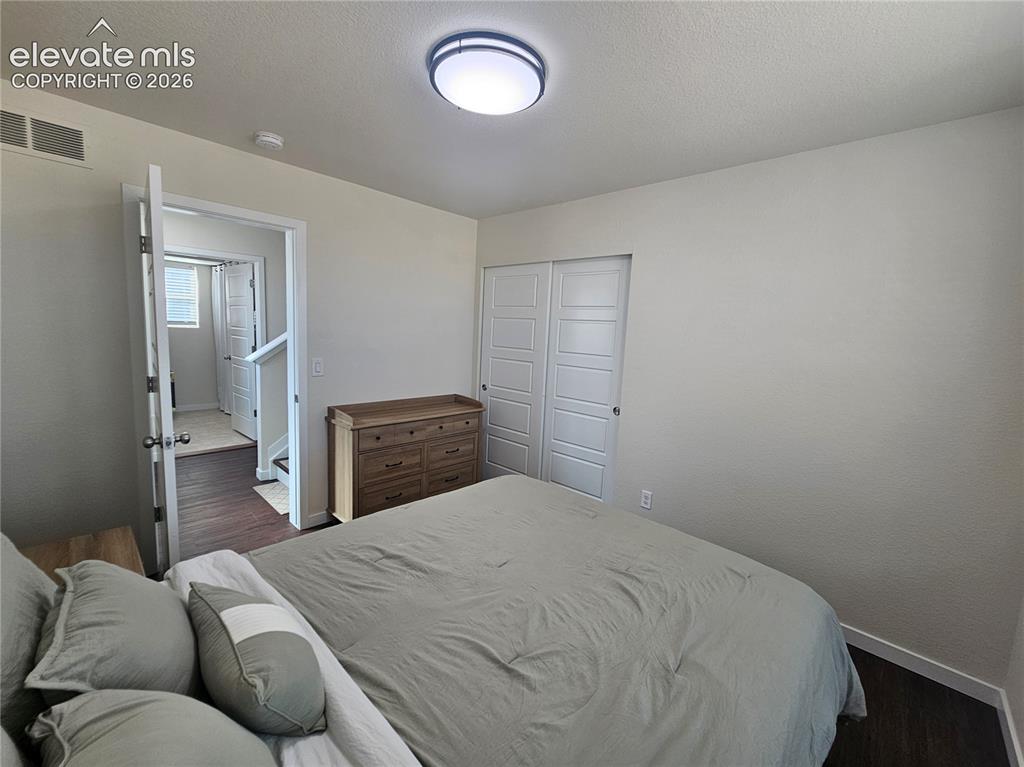 Image 18 of 23: Recessed lighting, wood-finish flooring, and white paneled closet doors