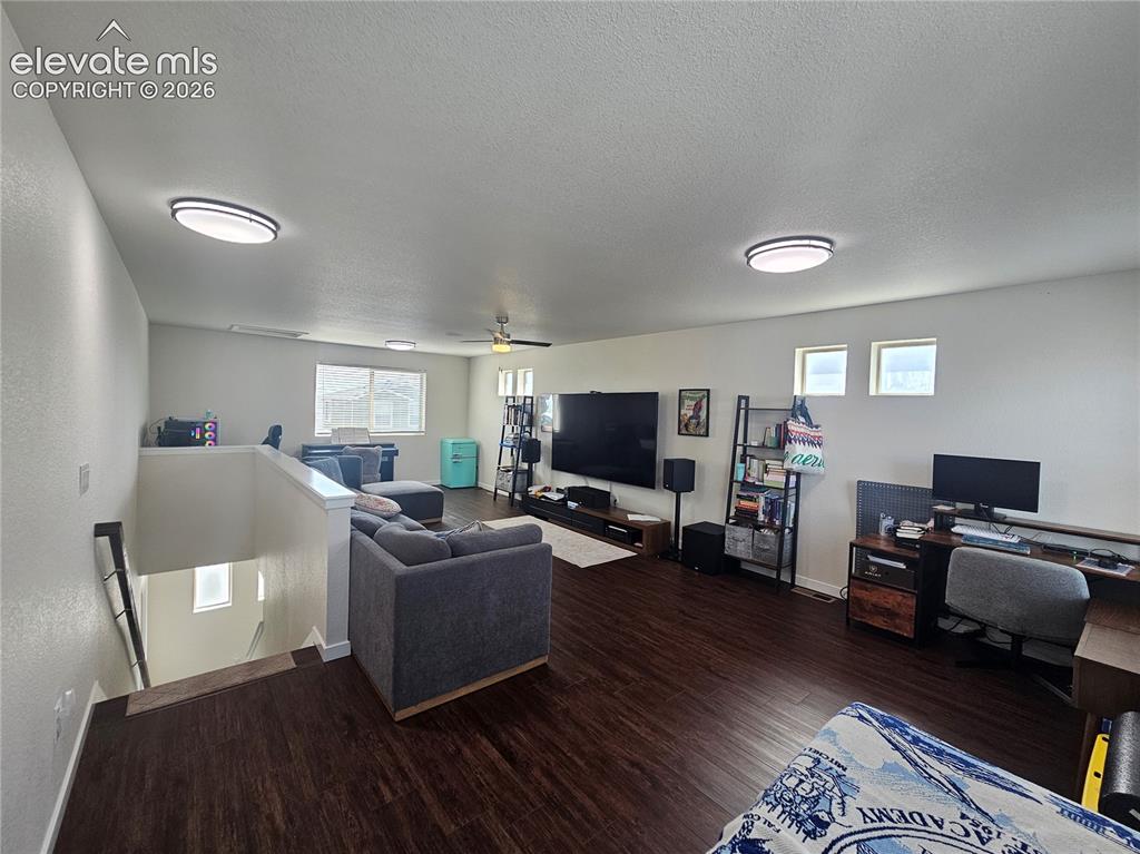 Image 20 of 23: Expansive open-concept room featuring wood-finish flooring, recessed lighti