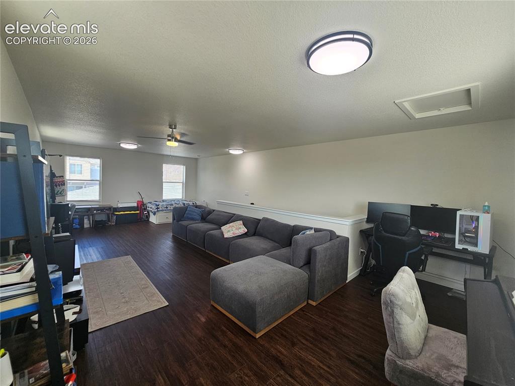 Image 21 of 23: Open concept area featuring wood-finish flooring, multiple windows, a ceili