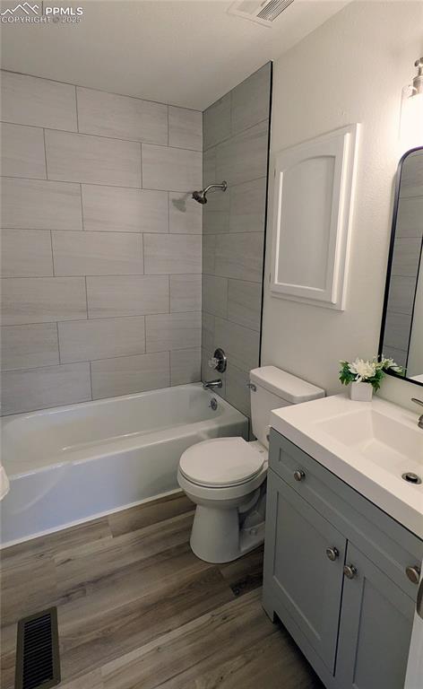 Image 17 of 39: Full bathroom featuring vanity, bathing tub / shower combination, and dark