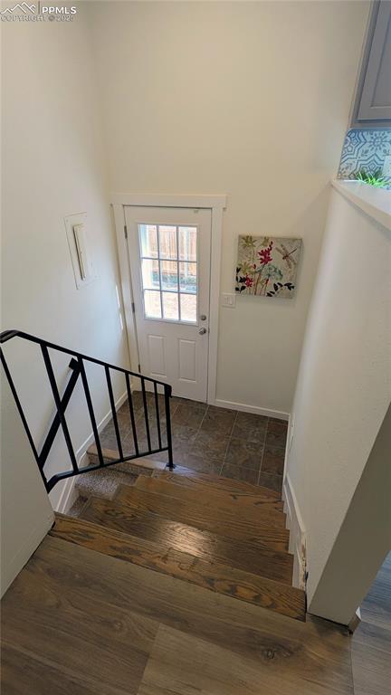 Image 19 of 39: Staircase with wood finished floors