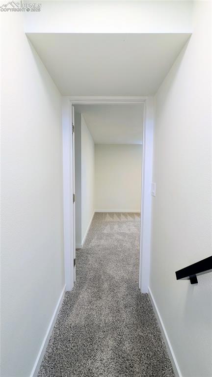 Image 20 of 39: Corridor with baseboards and light carpet