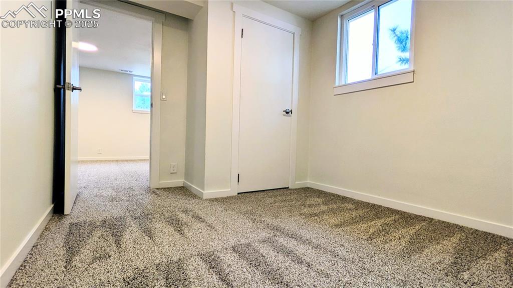 Image 23 of 39: Empty room with light carpet and baseboards