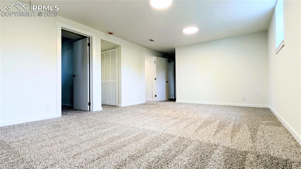 Image 25 of 39: Unfurnished bedroom featuring light colored carpet and a closet