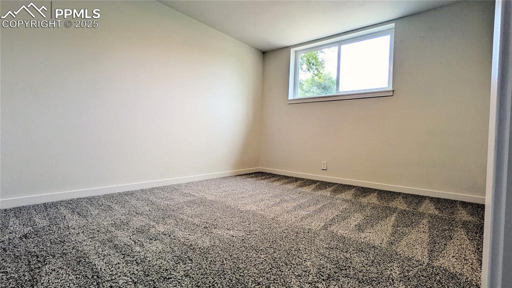 Image 26 of 39: Carpeted spare room featuring baseboards