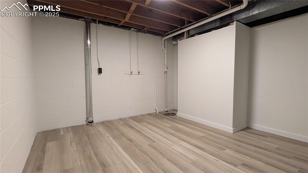 Image 29 of 39: Finished basement featuring light wood finished floors
