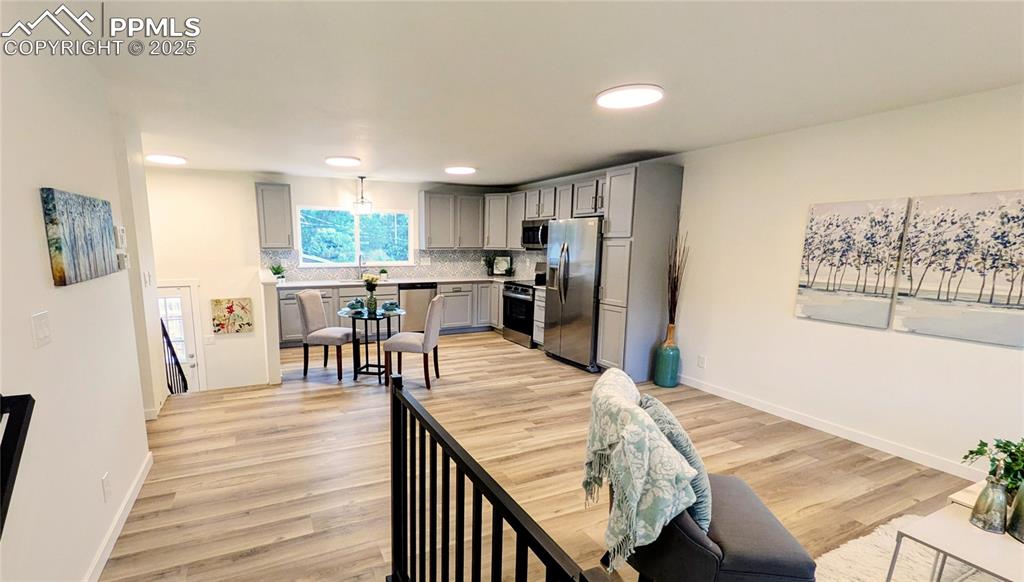 Image 3 of 39: Dining space featuring light wood finished floors and recessed lighting
