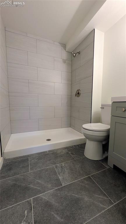 Image 30 of 39: Full bathroom with a stall shower and vanity