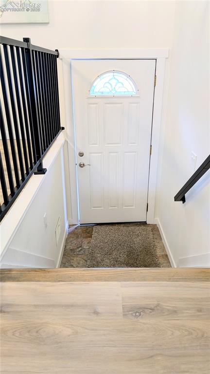 Image 34 of 39: Entrance foyer featuring stairs and wood finished floors