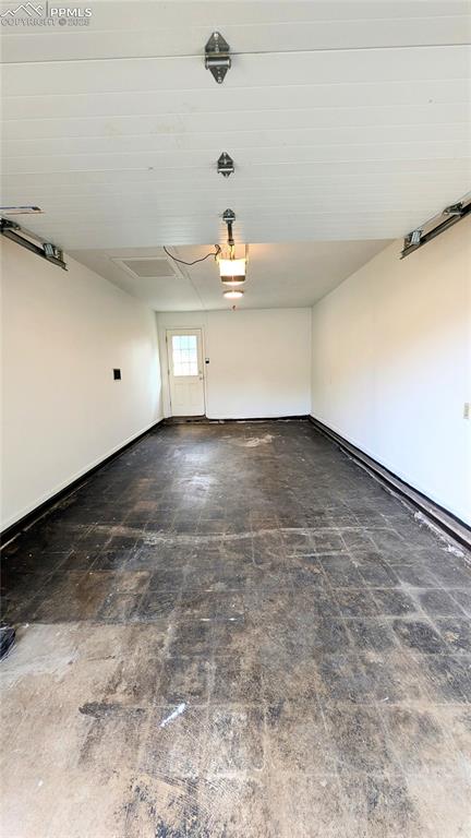 Image 39 of 39: Garage featuring baseboards