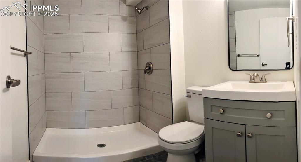 Image 5 of 39: Full bath with vanity and a stall shower
