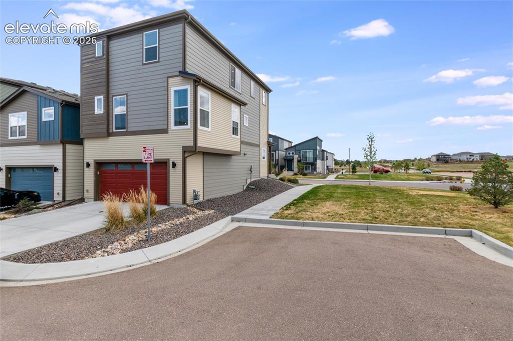 Image 4 of 43: Attached two car garage via alley access, right next to guest parking space
