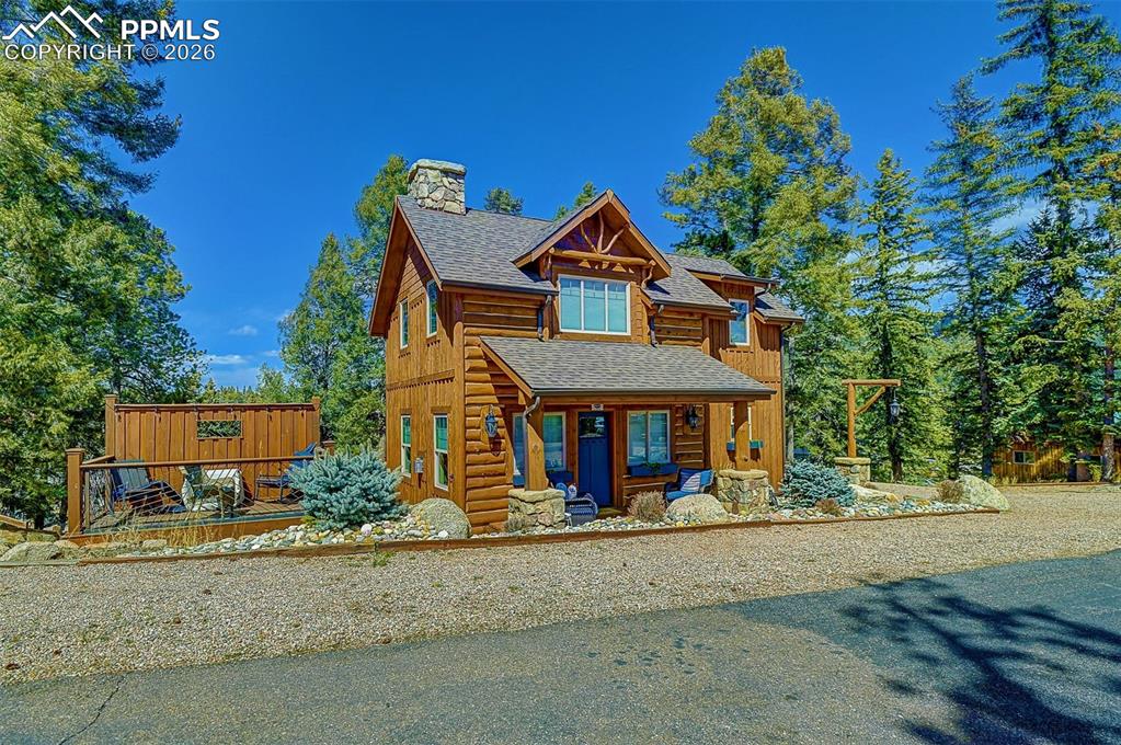 Image 3 of 28: View of front of house with a shingled roof, a chimney, and a porch