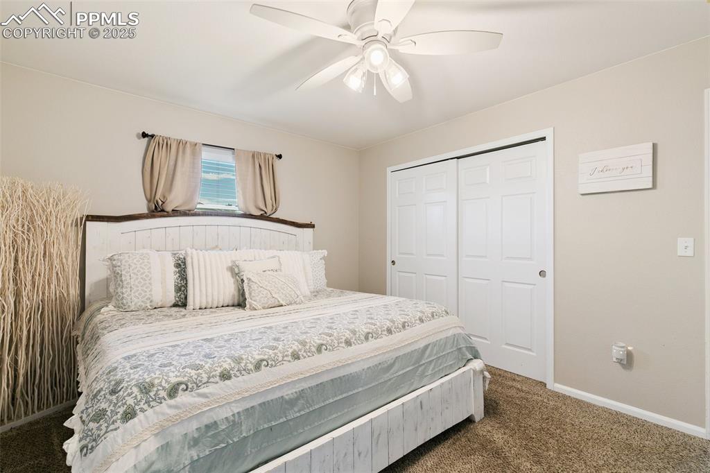 Image 14 of 27: Carpeted bedroom featuring a closet and a ceiling fan
