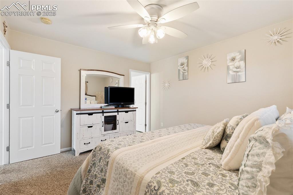 Image 15 of 27: Bedroom with carpet floors and ceiling fan