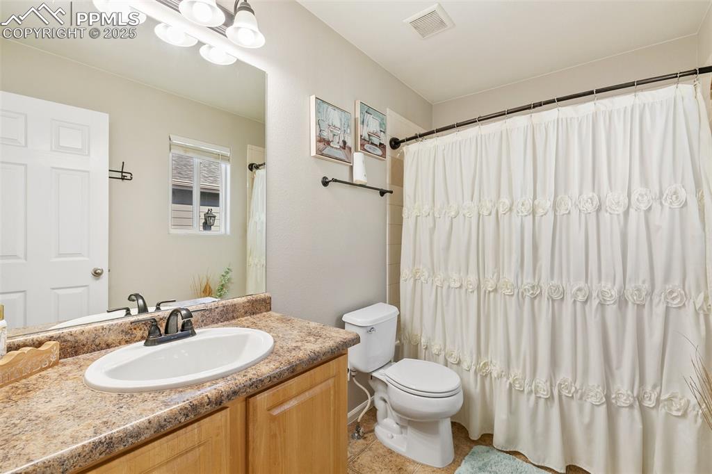Image 16 of 27: Full bath with vanity and tile patterned floors