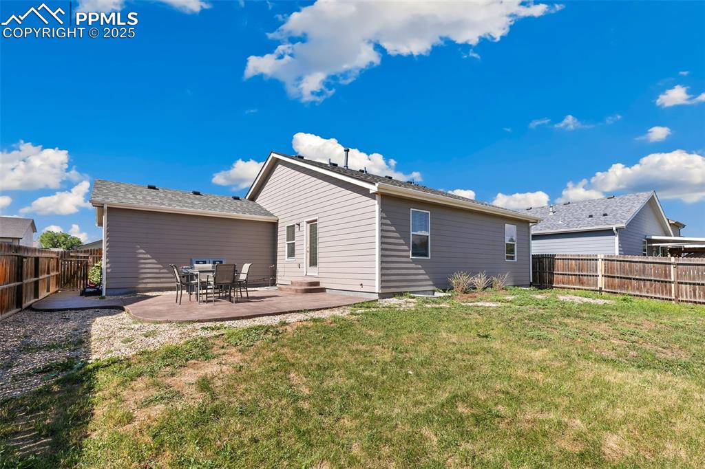 Image 27 of 27: Rear view of property with a fenced backyard and a patio area